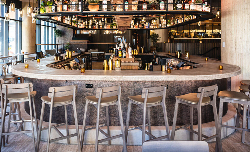 A driftwood finished Brooke bar stool at the Lyra restaurant in Chicago, IL.