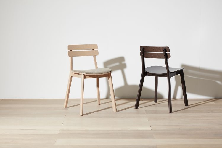 Two variations of the Brooke Chair in an empty room setting.
